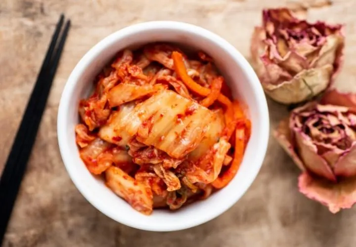A jar of homemade napa cabbage kimchi coated in red gochugaru paste