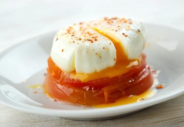 A vegan poached egg made from silken tofu with a yellow soy milk yolk, sitting on toast