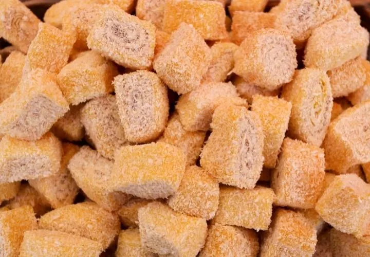 A pile of orange Turkish delight cubes rolled in sugar