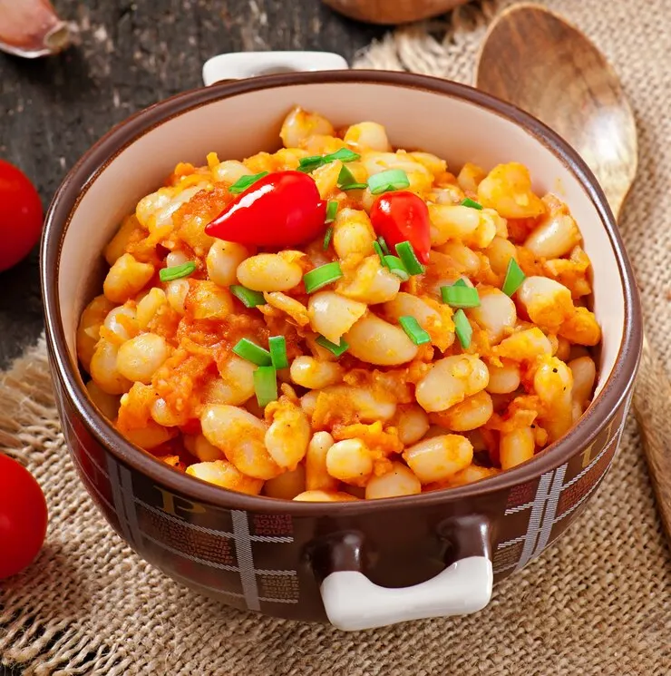 A bowl of Marry Me Butter Beans featuring beans, tomatoes, and herbs, inspired by a popular TikTok recipe.